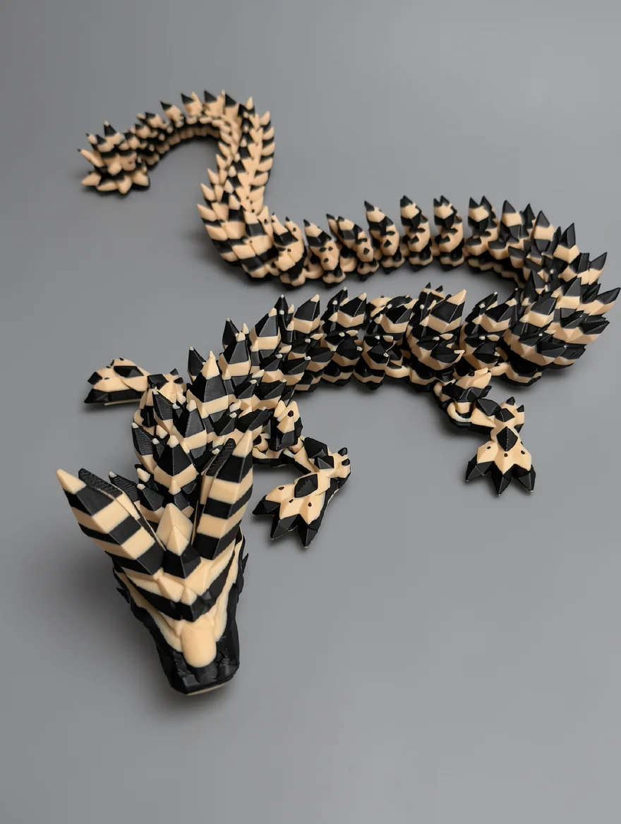 Crystal Dragon: black and cream articulated lizard or dragon figurine, segmented interlocking body construction