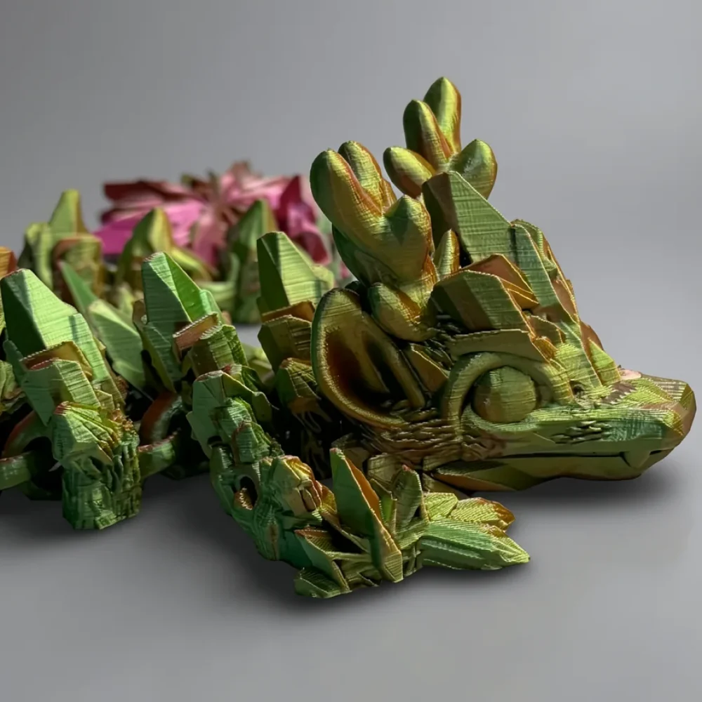 Baby Winter Dragon: green and orange dragon figurine, faceted low-poly geometry