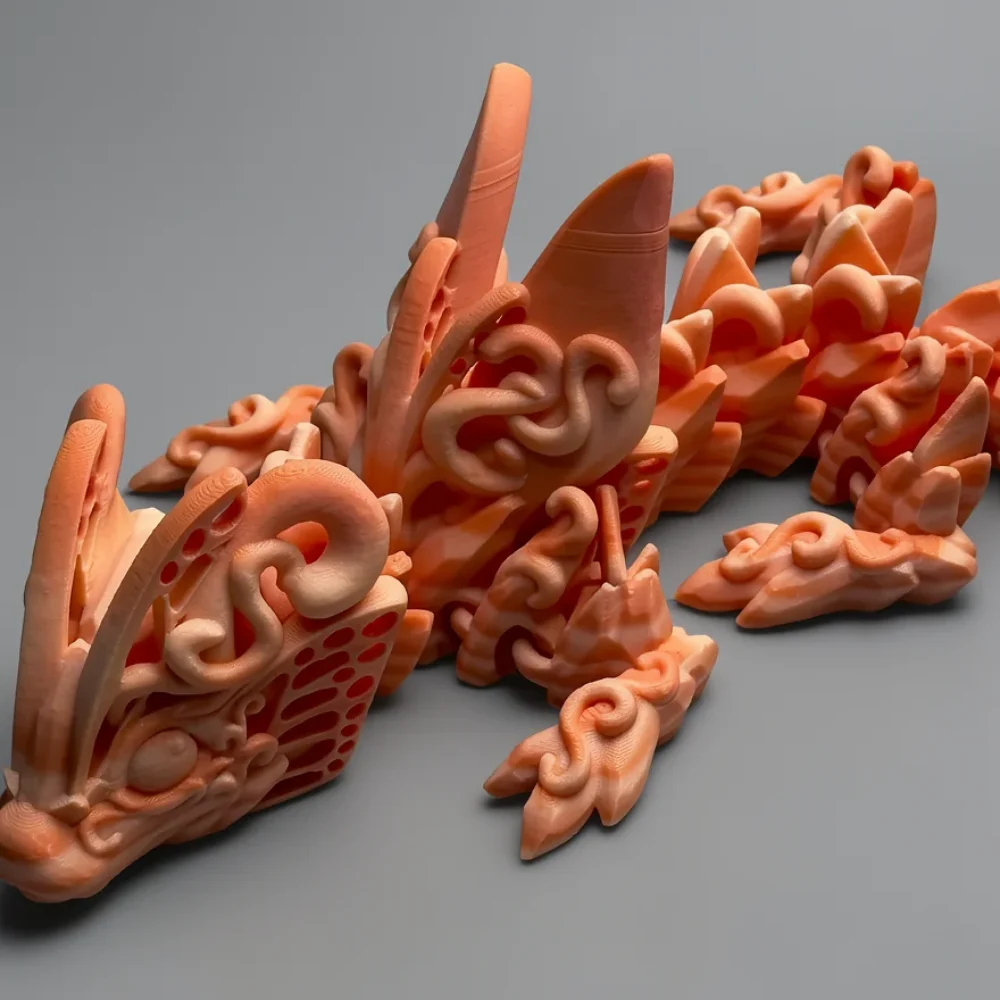 Baby Butterfly Dragon: peach (salmon/coral) and orange abstract biomorphic sculpture (fins, curled tendrils, perforated…