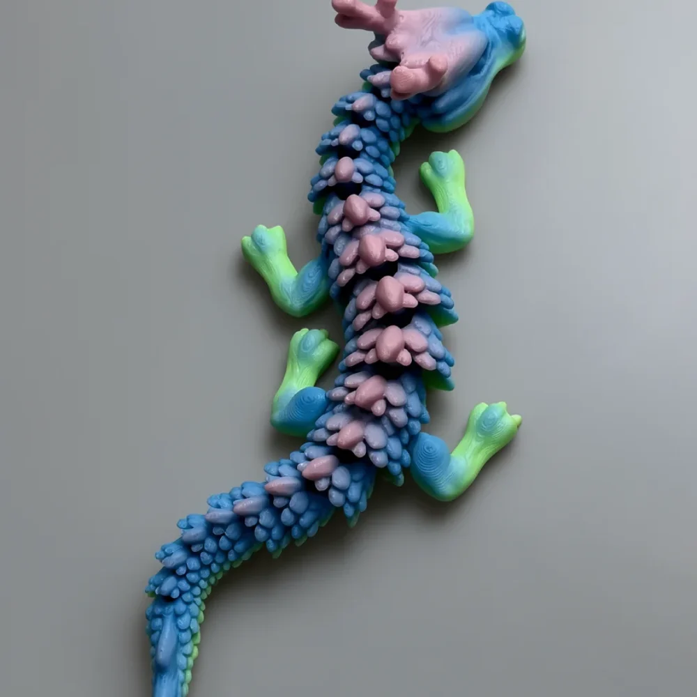 Jr Chinese Dragon: periwinkle blue and dusty pink dragon figurine, ridge of raised bulbous pale pink bumps along the spine