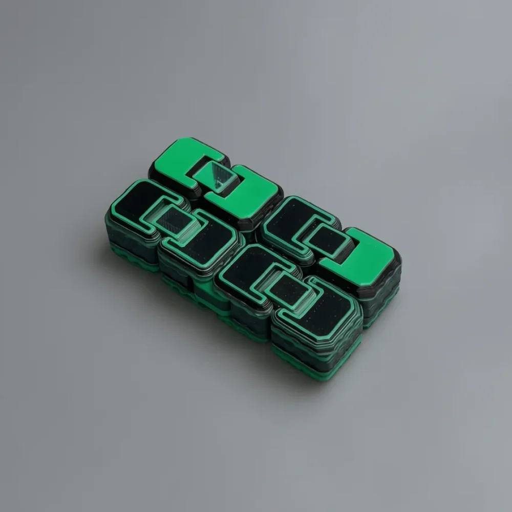Infinity Cube: green and black abstract geometric logo-style sculpture of four interlocking blocky modules (glyph/monogram…