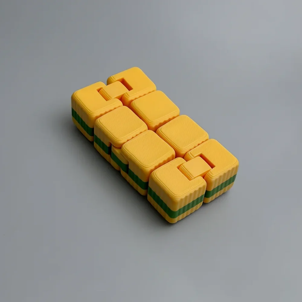 Infinity Cube: yellow and green segmented interlocking puzzle block structure
